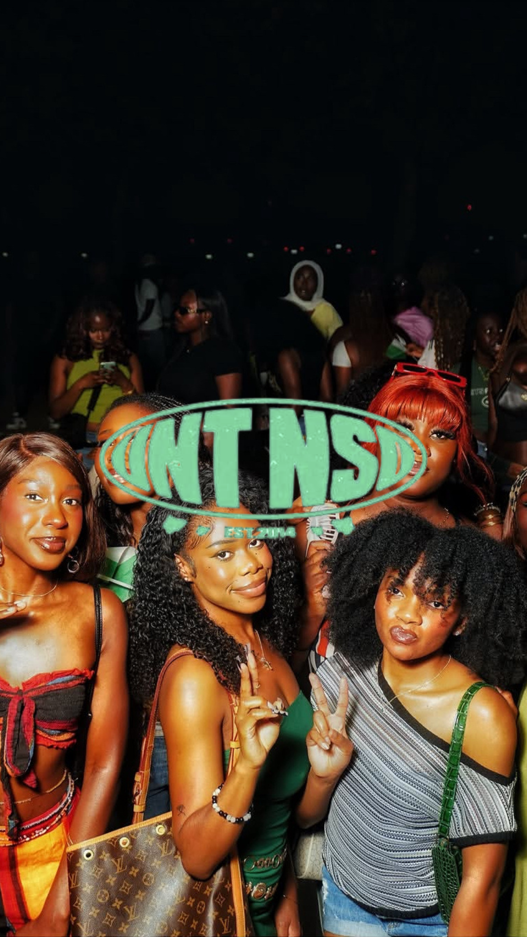 Event content reel — a group of young women pose together at a night outdoor event beneath the TNT NSD EST 2014 logo